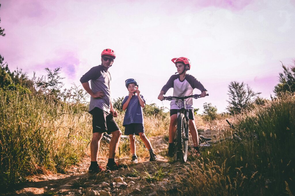 A family enjoys mountain biking on a scenic trail, capturing an adventurous outdoor moment.